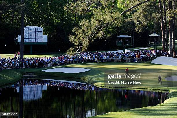 Tiger Woods and K.J. Choi of South Korea walk to the 16th green during the final round of the 2010 Masters Tournament at Augusta National Golf Club...