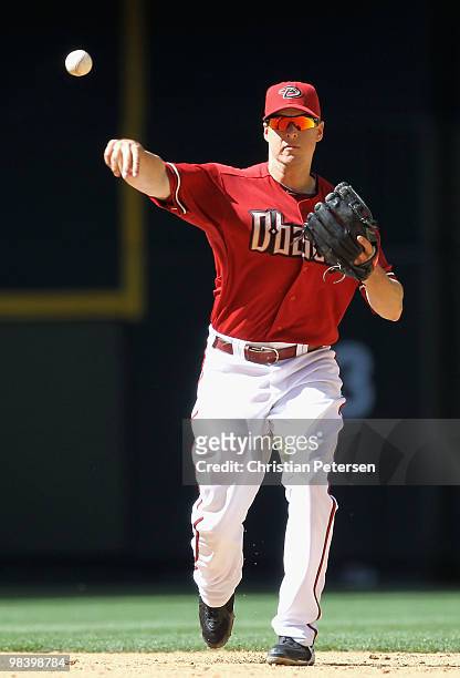 Infielder Kelly Johnson of the Arizona Diamondbacks fields a ground ball out against the Pittsburgh Pirates during the major league baseball game at...