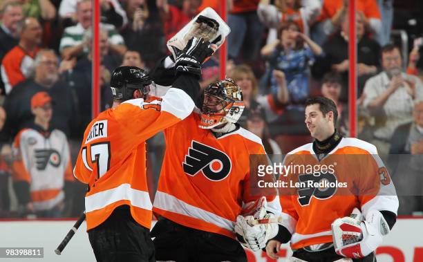 Jeff Carter, Brian Boucher and Sebastien Caron of the Philadelphia Flyers all celebrate a 2-1 shootout win over the New York Rangers on April 11,...