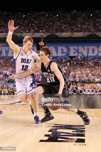 Gordon Hayward of the Butler Bulldogs drives against Kyle Singler of the Duke Blue Devils during the 2010 NCAA Division I Men's Basketball National...