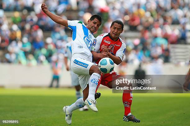 Joaquin Velazquez of Puebla fights for the ball with Daniel Frias of Indios during a match as part of the 2010 Bicentenary Tournament at the...