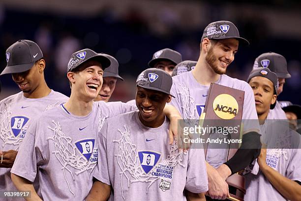 Jon Scheyer, Nolan Smith and Brian Zoubek of the Duke Blue Devils celebrate with the trophy after they won 61-59 against the Butler Bulldogs during...