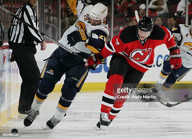 Paul Gaustad of the Buffalo Sabres and Paul Martin of the New Jersey Devils battle for position on a loose puck during the game at the Prudential...