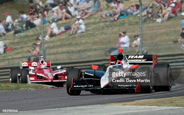 Helio Castroneves of Brazil, driver of the Team Penske Dallara Honda leads Scott Dixon of New Zealand, driver of the Target Chip Ganassi Racing...