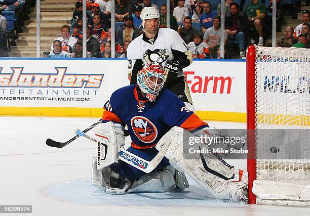 Bill Guerin of the Pittsburgh Penguins watches a puck hit by teammate Evengi Malkin fly past Dwayne Roloson of the New York Islanders on April 11,...