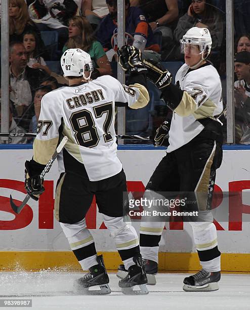 Sidney Crosby of the Pittsburgh Penguins congratulates Evgeni Malkin on his second period goal against the New York Islanders at the Nassau Coliseum...