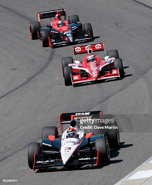 Helio Castroneves of Brazil, driver of the Team Penske Dallara Honda leads Scott Dixon of New Zealand, driver of the Target Chip Ganassi Racing...