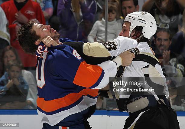 Joel Rechlicz of the New York Islanders fights with Eric Godard of the Pittsburgh Penguins at the Nassau Coliseum on April 11, 2010 in Uniondale, New...