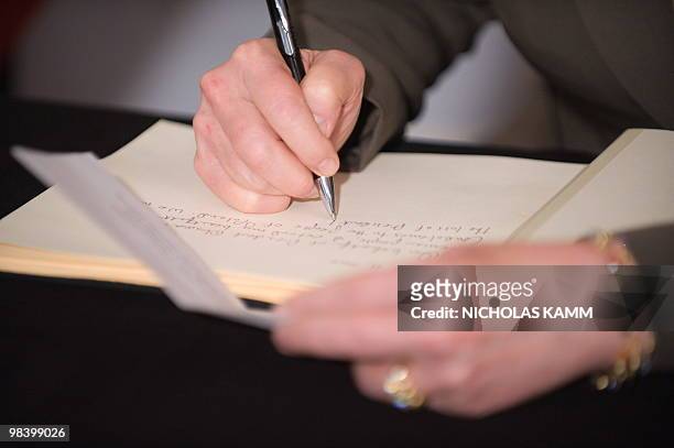 Secretary of State Hillary Clinton signs the condolence book at the Polish embassy in Washington on April 11 one day after Polish President Lech...