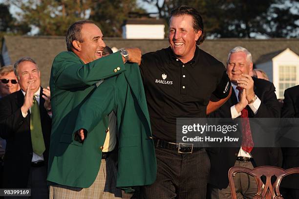 Angel Cabrera of Argentina presents Phil Mickelson with the green jacket during the green jacket presentation after the final round of the 2010...