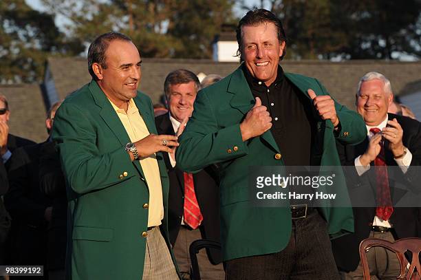 Angel Cabrera of Argentina presents Phil Mickelson with the green jacket during the green jacket presentation after the final round of the 2010...