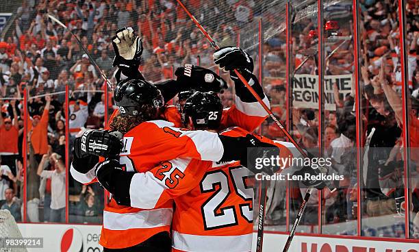 Matt Carle of the Philadelphia Flyers is mobbed by his teammates after scoring the game tying goal in the third period against the New York Rangers...