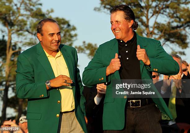 Angel Cabrera of Argentina presents Phil Mickelson with the green jacket during the green jacket presentation after the final round of the 2010...