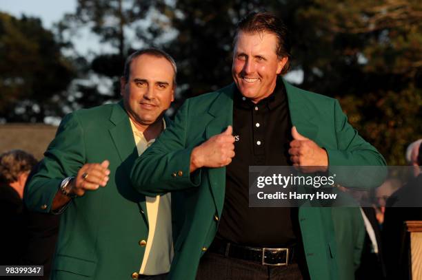 Angel Cabrera of Argentina presents Phil Mickelson with the green jacket during the green jacket presentation after the final round of the 2010...