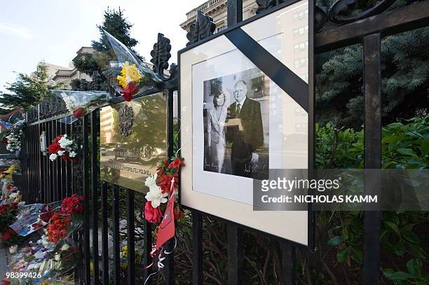 Picture of late Polish President Lech Kaczynski and his wife Maria hangs on the gate in front of the Polish embassy in Washington on April 11 one day...