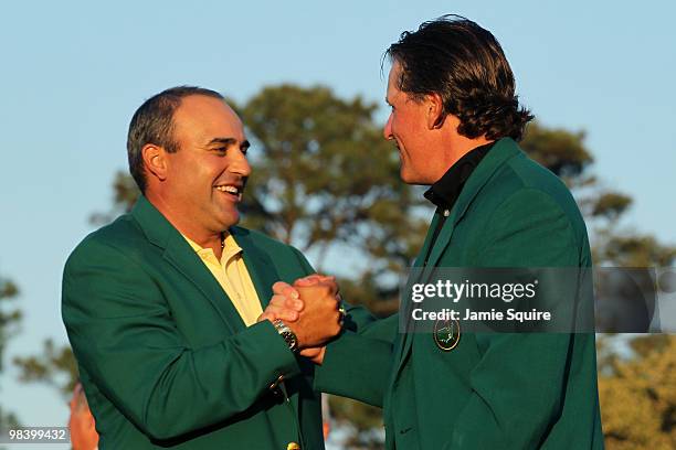 Angel Cabrera of Argentina presents Phil Mickelson with the green jacket during the green jacket presentation after the final round of the 2010...