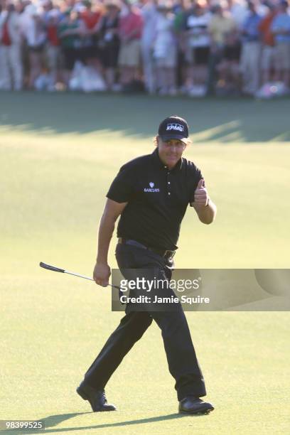 Phil Mickelson acknowledges the gallery on the 18th hole during the final round of the 2010 Masters Tournament at Augusta National Golf Club on April...