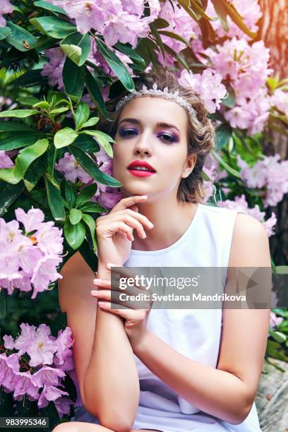 girl in dress in rhododendron garden - superficie lateral fotografías e imágenes de stock