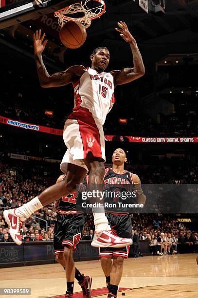 Amir Johnson of the Toronto Raptors finishes the alley-oop with a monster two-handed jam ahead of Derrick Rose of the the Chicago Bulls during a game...