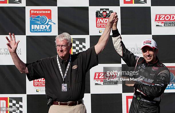 Helio Castroneves of Brazil, driver of the Team Penske Dallara Honda celebrates in victory lane with George Barber after winning the Indy Grand Prix...