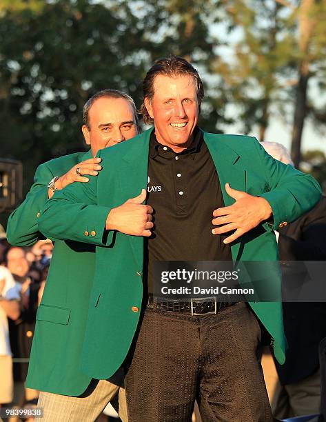 Angel Cabrera of Argentina presents Phil Mickelson with the green jacket during the green jacket presentation after the final round of the 2010...