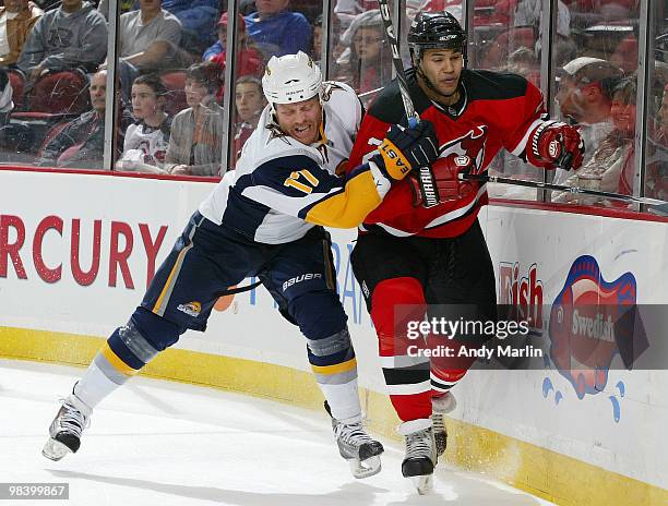 Raffi Torres of the Buffalo Sabres checks Mark Fraser of the New Jersey Devils during the game at the Prudential Center on April 11, 2010 in Newark,...