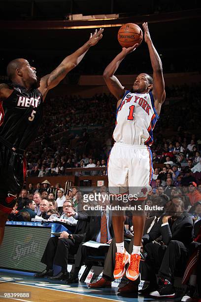 Chris Duhon of the New York Knicks shoots against Quentin Richardson of the Miami Heat on April 11, 2010 at Madison Square Garden in New York City....