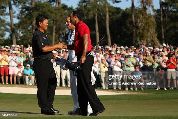 Choi of South Korea and Tiger Woods shake hands on the 18th green after finishing the final round of the 2010 Masters Tournament at Augusta National...