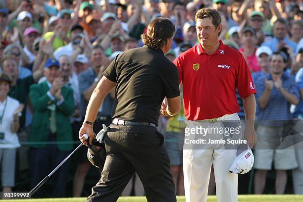 Phil Mickelson shakes hands with Lee Westwood of England on the 18th green after Mickelson's three-stroke victory at the 2010 Masters Tournament at...