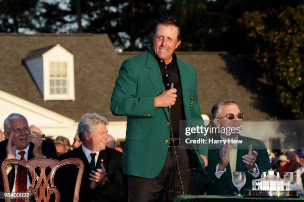 Phil Mickelson speaks to the gallery as Augusta National Chairman William Porter "Billy" Payne looks on during the green jacket presentation after...