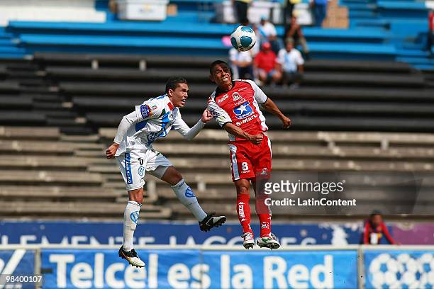 Herculez Gomez of Puebla fights for the ball with Tomas Campos of Indios during a match as part of the 2010 Bicentenary Tournament at the Cuauhtemoc...