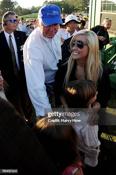 Reinman of Gaylord Sports congratulates Amy Mickelson and family on Phil Mickelson's , three-stroke victory at the 2010 Masters Tournament at Augusta...