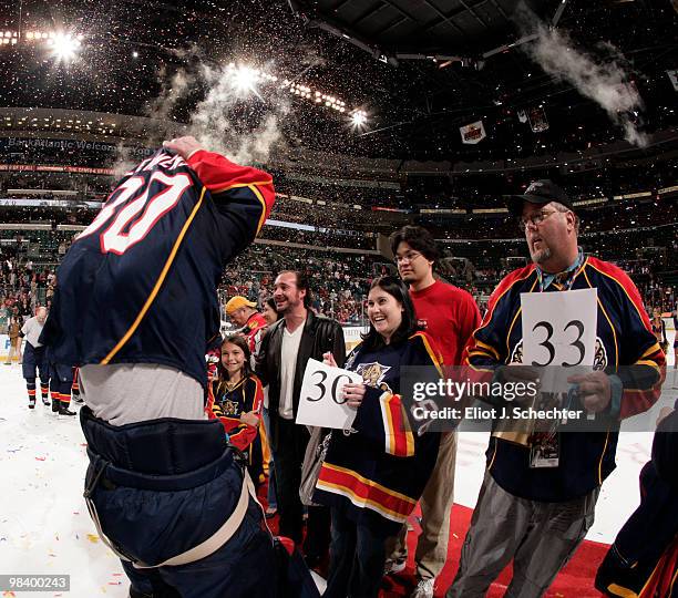 Goaltender Scott Clemmensen of the Florida Panthers pulls his shirt off his back to give to a fan after the final game of the season against the...