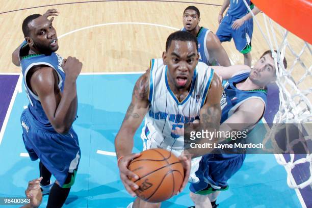 Marcus Thornton of the New Orleans Hornets shoots over Al Jefferson, Ryan Gomes and Kevin Love of the Minnesota Timberwolves on April 11, 2010 at the...