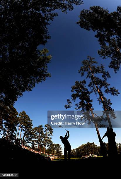 Phil Mickelson plays his tee shot on the 14th hole as Lee Westwood of England looks on during the final round of the 2010 Masters Tournament at...