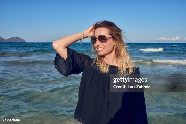 happy attractive blond woman at the seaside - women in see through tops stock pictures, royalty-free photos & images