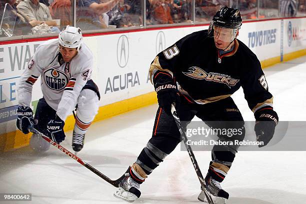 Jason Blake of the Anaheim Ducks defends against Jason Strudwick of the Edmonton Oilers during the game on April 11, 2010 at Honda Center in Anaheim,...