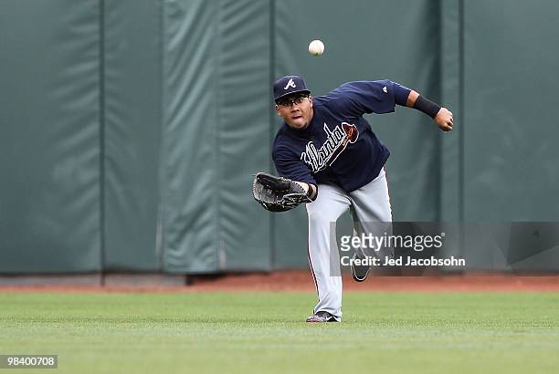 Melky Cabrera of the Atlanta Braves catches a ball hit by Bengie Molina of the San Francisco Giants in the second inning during an MLB game at AT&T...