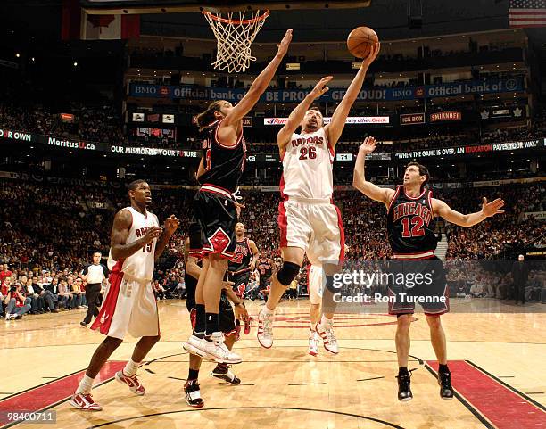 Hedo Turkoglu of the Toronto Raptors drives the paint for the layup defended by Joakim Noah of the Chicago Bulls during a game on April 11, 2010 at...