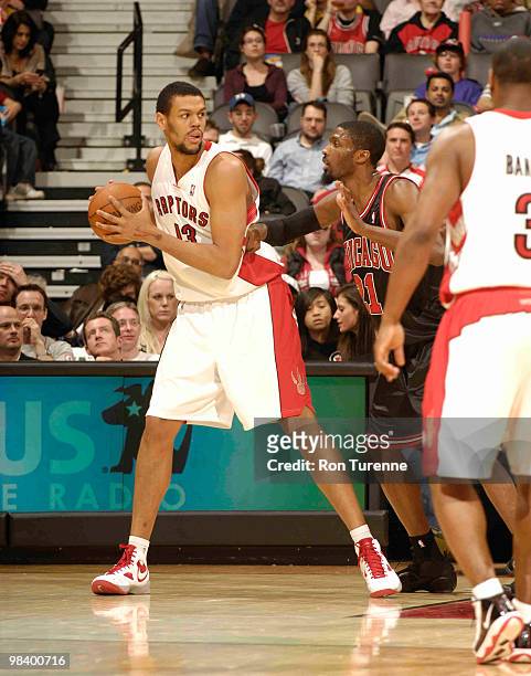 Patrick O'Bryant of the Toronto Raptors looks to post up and back down defender Hakim Warrick of the Chicago Bulls during a game on April 11, 2010 at...