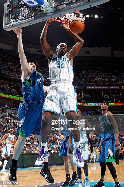 Julian Wright of the New Orleans Hornets dunks on Kevin Love and Corey Brewer of the Minnesota Timberwolves on April 11, 2010 at the New Orleans...