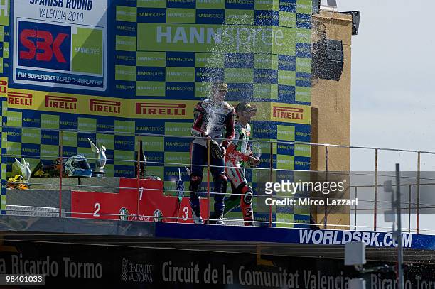 Max Biaggi of Italy and Aprilia Alitalia Racing and Carlos Checa of Spain and Althea Racing celebrate on the podium at the end of race 2 of the...