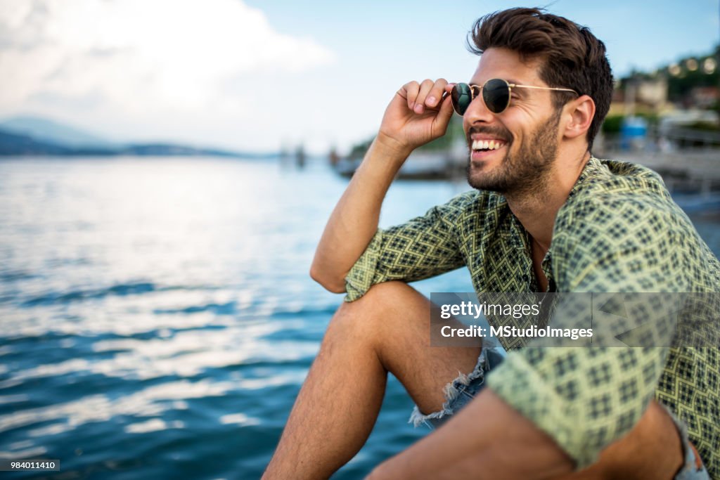 Handsome smiling man looking away.