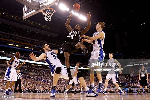 Avery Jukes of the Butler Bulldogs loses the ball as he drives against Brian Zoubek and Jon Scheyer of the Duke Blue Devils during the 2010 NCAA...