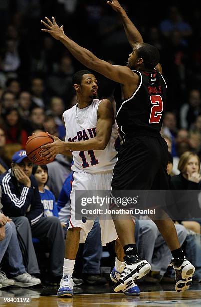 Jeremiah Kelly of the DePaul Blue Demons tries to pass under pressure from Preston Knowles of the Louisville Cardinals at the Allstate Arena on...