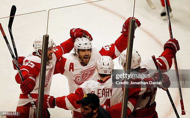 Niklas Kronwall and Henrik Zetterberg of the Detroit Red Wings celebrate the winning goal against the Chicago Blackhawks by teammate Brad Stuart at...