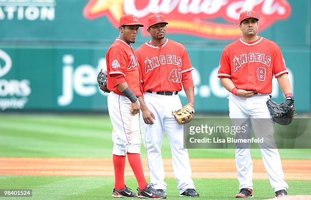 Erick Aybar, Howie Kendrick and Kendry Morales of the Los Angeles Angels of Anaheim look on during a pitching change against the Oakland Athletics at...