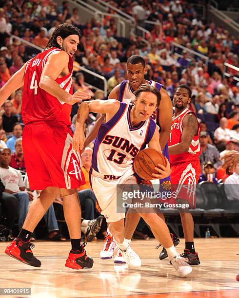 Steve Nash of the Phoenix Suns drives past Luis Scola of the Houston Rockets in an NBA Game played on April 11, 2010 at U.S. Airways Center in...