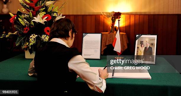 Consular staff member Magdalena Falasa signs a book of condolences at the Consulate General of the Republic of Poland in Sydney on April 12, 2010 in...