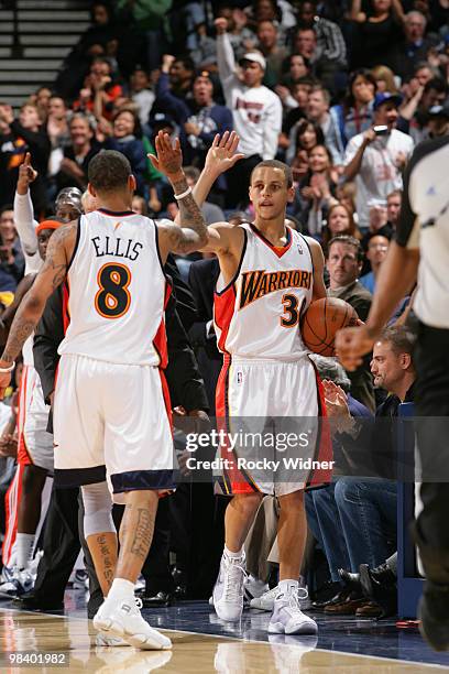 Stephen Curry and Monta Ellis of the Golden State Warriors give each other a high five in a game against the Oklahoma City Thunder on April 11, 2010...